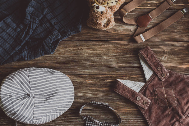 Flat lay photography of boy's casual outfits, Outfits of traveler, boy, male, Men's casual outfits on wood board background - Vintage effect style picture - Photo, Image