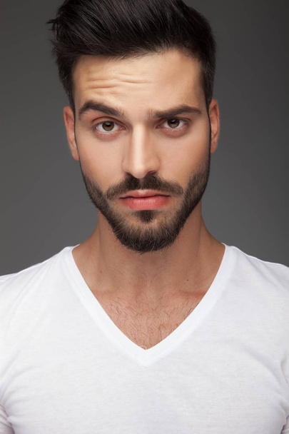 portrait of a cute man with raised eyebrow  - Foto, Imagen