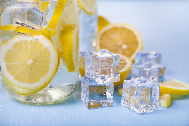 Refreshing ice cold water with lemon  - Фото, изображение