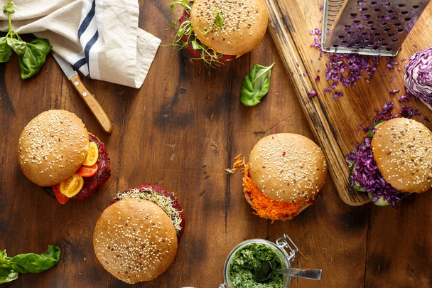 Healthy food background. Set different vegetarian burgers on a wooden background with copy space, top view - Foto, Bild
