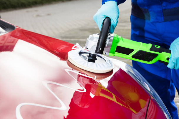 Close-up Of Person's Hand Polishing Car Hood With Orbital Polisher And Cleaner Compound - Foto, Bild
