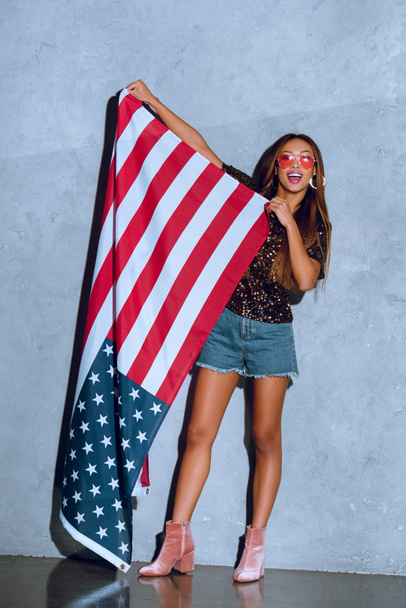 cheerful african american woman holding american flag in hands - Photo, Image