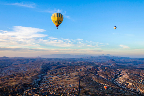 Hot air balloon flying over valleys in Cappadocia Turkey - Фото, зображення