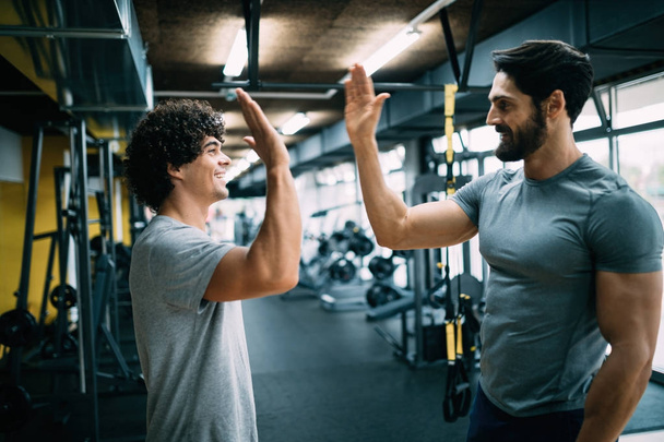 Young man doing workout with a personal trainer. - Φωτογραφία, εικόνα