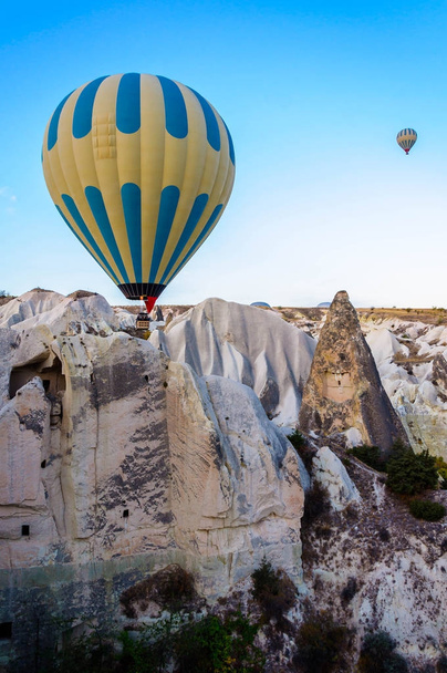 Hot air balloon flying over valleys in Cappadocia Turkey - Fotografie, Obrázek