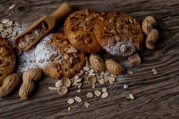 stack of homemade cookies with nuts and wooden spoon on wooden table, top view - Φωτογραφία, εικόνα