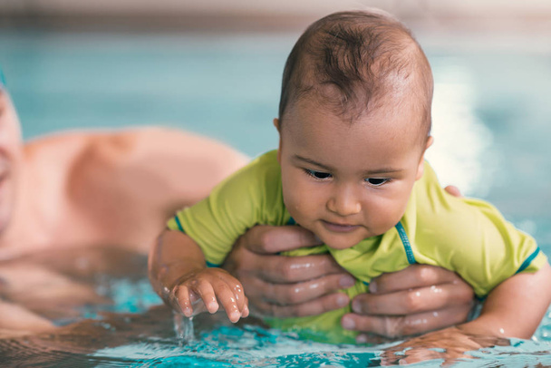 Father with baby boy in the swimming pool  - Photo, Image