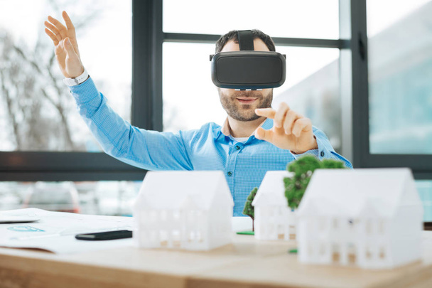 Handsome architect trying out VR headset at work - 写真・画像