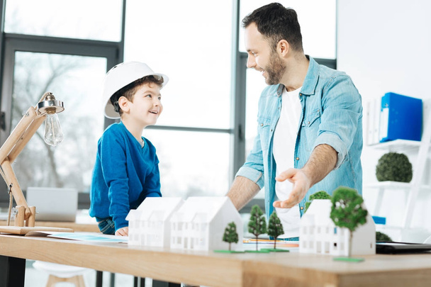 Cheerful architect talking about work with his son - Foto, Imagen