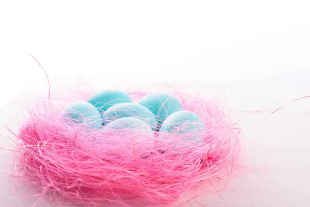 Easter eggs in a pink nest. - Foto, Imagen