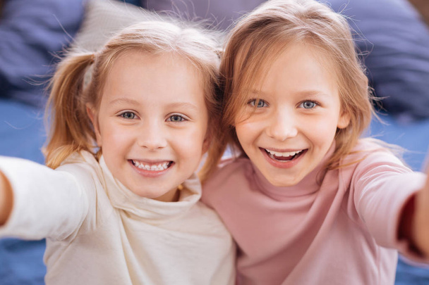 Sweet happy blond sisters laughing - Photo, Image