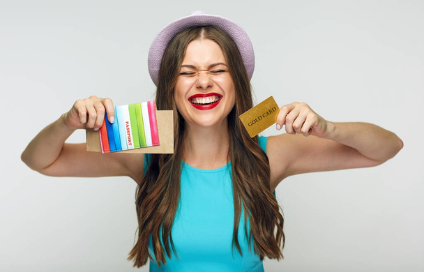 smiling woman wearing blue dress holding credit cart and passport, travel concept  - Фото, зображення