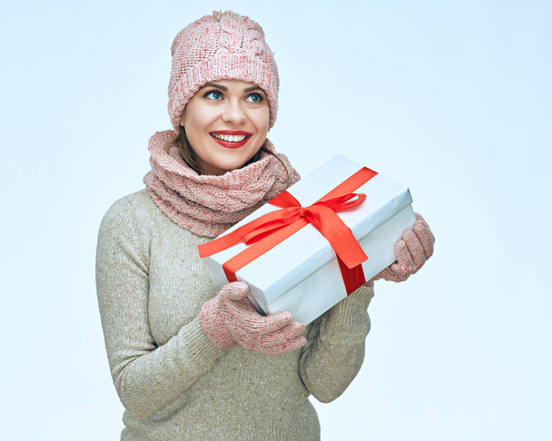 smiling woman wearing warm casual clothes hold white gift box. - Photo, Image