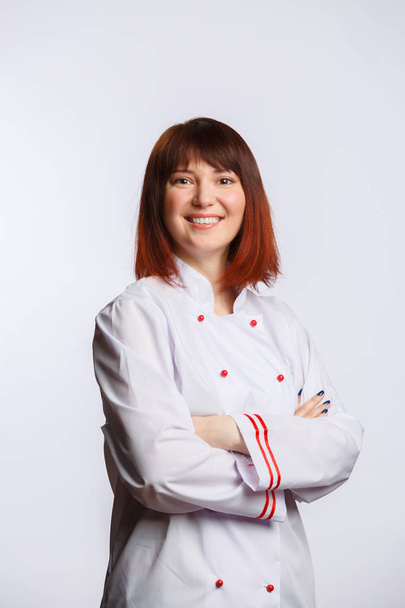 Picture of brunette chef in white robe with arms crossed at waist - Fotografie, Obrázek