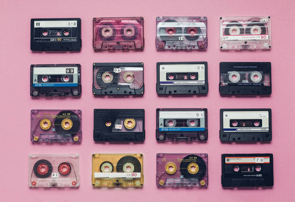 Collection Of Retro Audio Tapes In Row  On Lilac Background. Retro Technology Music Concept - Photo, image