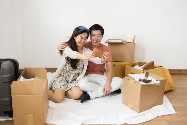 happy couple taking selfie in new home - Photo, Image