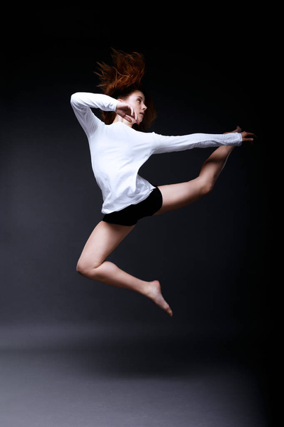 Young contemporary dancer is posing in studio - Фото, изображение