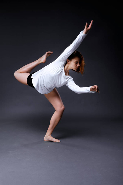 Young contemporary dancer is posing in studio - Photo, Image
