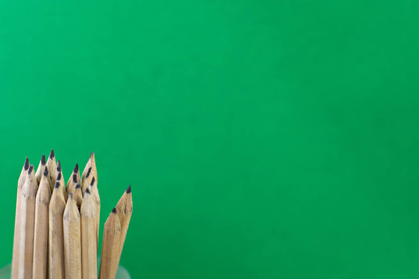 Pencils on green background in concept education. - Fotoğraf, Görsel