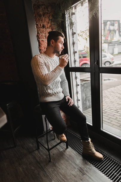 Man in cafe. lifestyle portrait of cute boy in sweater. Rustic styling - Foto, Imagem