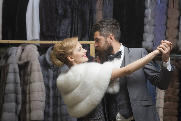Woman in fur coat with man, shopping, seller and customer. - Фото, зображення