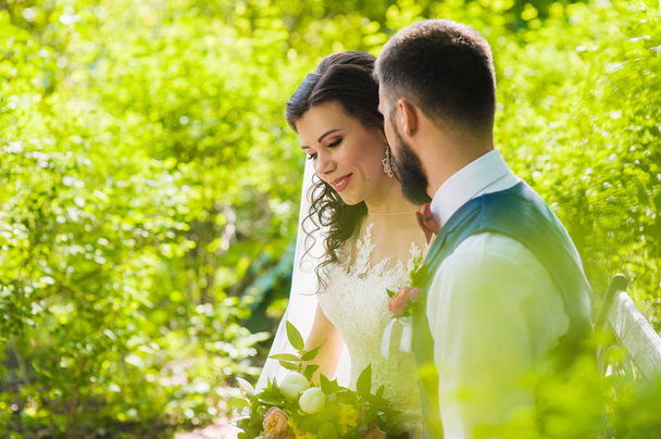 Portrait of bride and groom in fairytale park - Photo, Image