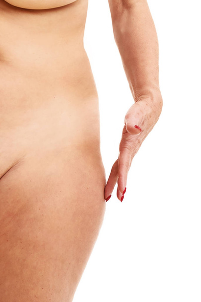 Senior woman touching abdomen over white background - Photo, Image