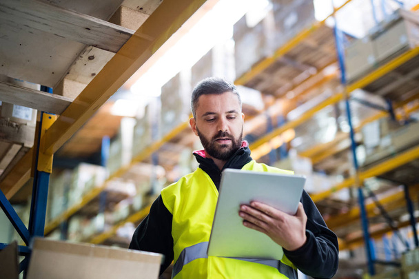 Male warehouse worker with tablet. - Photo, Image