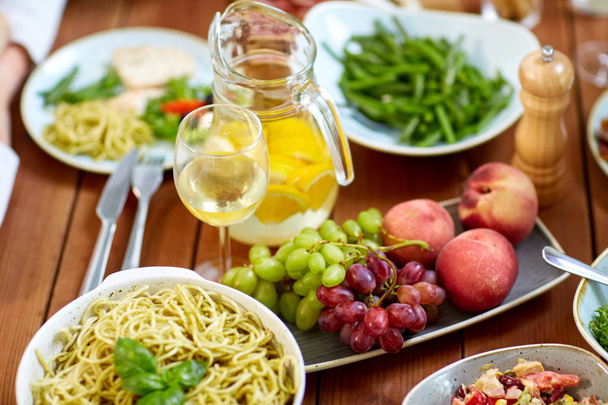 fruits, salads and pasta on wooden table - Φωτογραφία, εικόνα