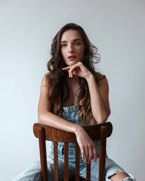 Brunette girl Caucasian race sits on a Chair - Photo, Image
