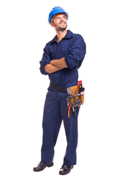 Full length of a young worker standing on a white background - Foto, Imagen