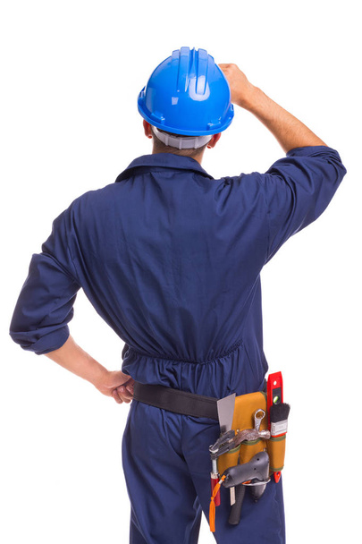 Back view of a thoughtful worker standing on a white background - Foto, immagini