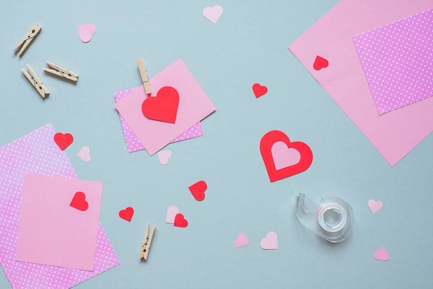 Valentines day background. Valentine card with heart and craft paper on the blue background - Фото, изображение