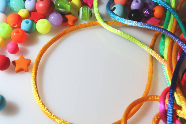 colorful beads and thread on white background - 写真・画像