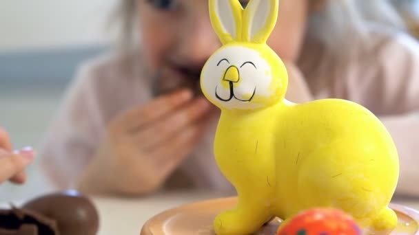 Little girl eating Chocolate Easter Eggs - 映像、動画