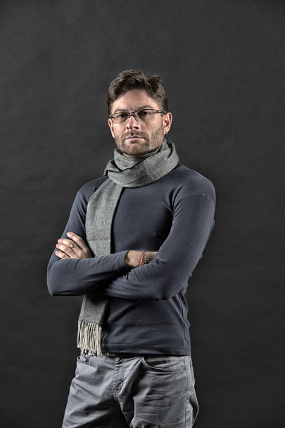 Man in scarf and sweater with folded hands. Businessman in glasses on bearded face. Vision, business, future concept. Fashion, eyewear, accessory. Eyesight correction, eye care, health, vintage filter - Fotografie, Obrázek