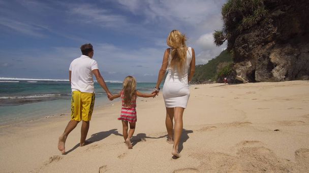 Family with child on the beach. - Photo, Image