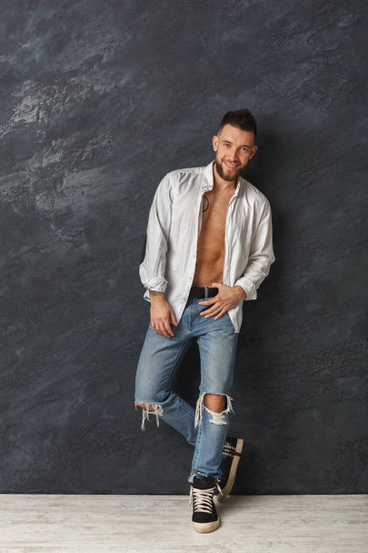 Handsome smiling man with athletic body in studio - Photo, Image