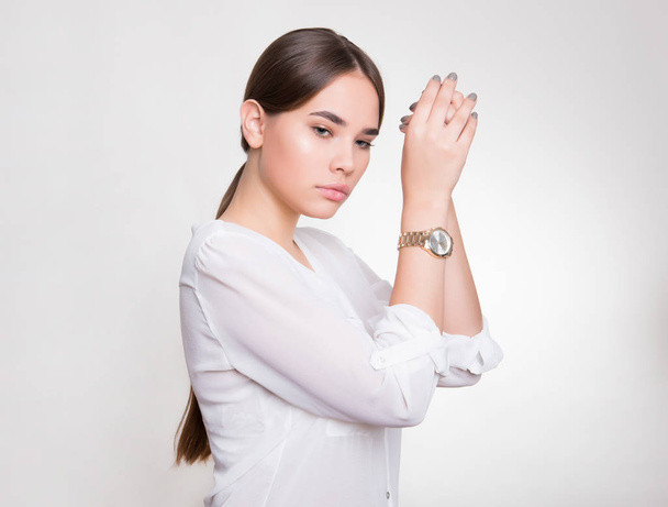 beautiful young woman with long hair wearing wrist watch - Fotó, kép