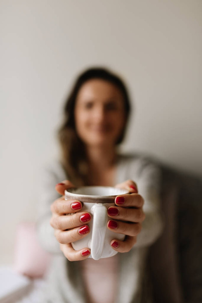 Unrecognizable woman holding a cup of coffee. - Φωτογραφία, εικόνα