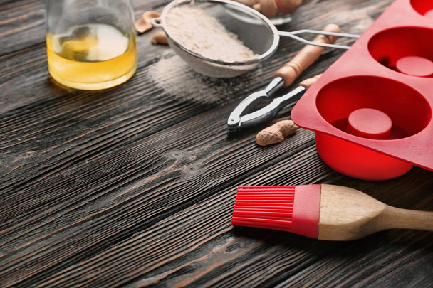 Kitchen utensils and ingredients for pastries on wooden surface - Fotoğraf, Görsel