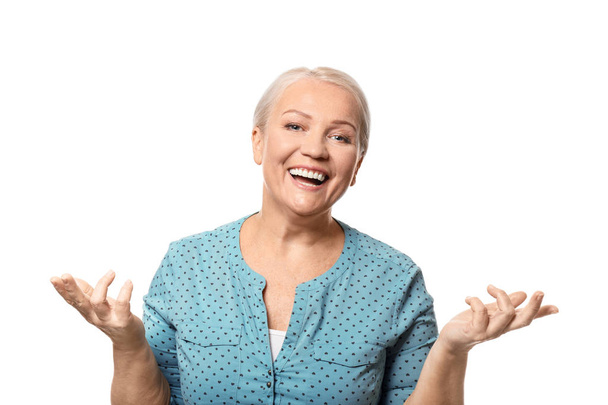 Portrait of smiling mature woman on white background - Фото, изображение