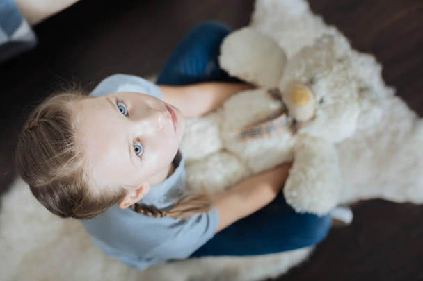 Lonely child hugging her favourite toy - Fotografie, Obrázek