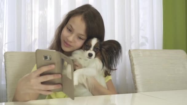 Happy teenage girl doing selfie with her dog stock footage video - Кадри, відео