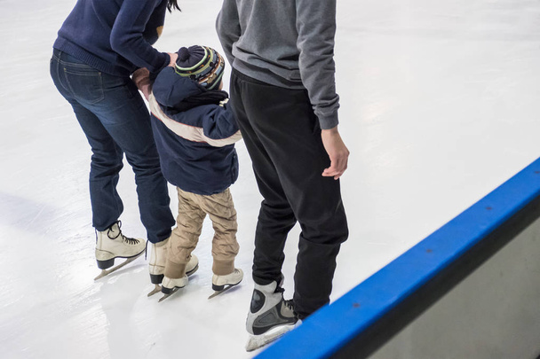 Family ice skating at rink. Winter activities - Zdjęcie, obraz