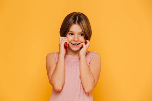 Cheerful little lady talking on phone isolated - Foto, imagen