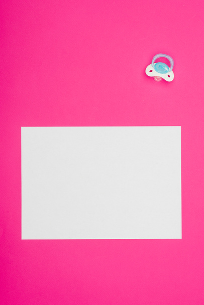 top view of empty board with baby dummy isolated on pink - Photo, Image
