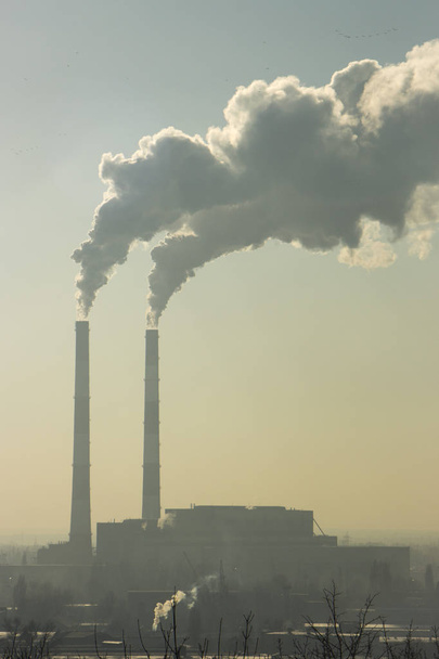 Smoke from industrial chimneys against the blue sky. Pollution. - Photo, Image