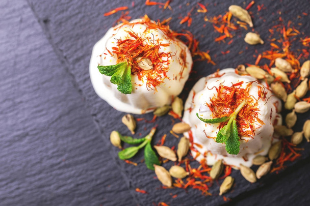 Indian kulfi dessert, ice cream with safron, mint, nuts - 写真・画像