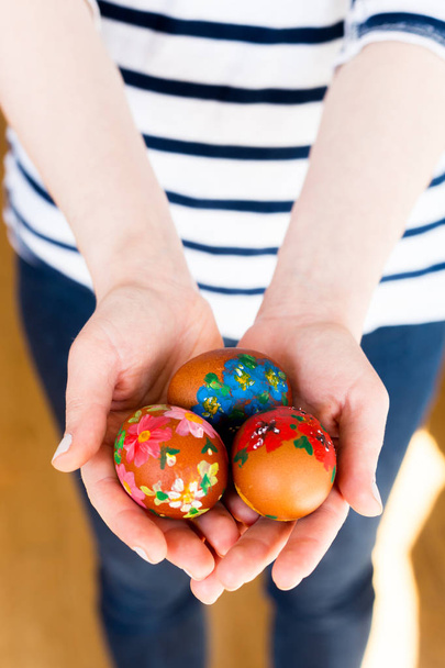 Close up of young woman holding colorful painted Easter eggs - Photo, Image